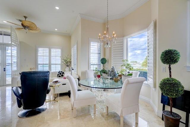 dining room with an inviting chandelier, crown molding, and french doors