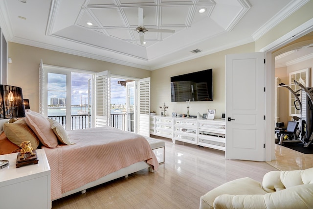 bedroom featuring light hardwood / wood-style floors, access to outside, ornamental molding, and a raised ceiling