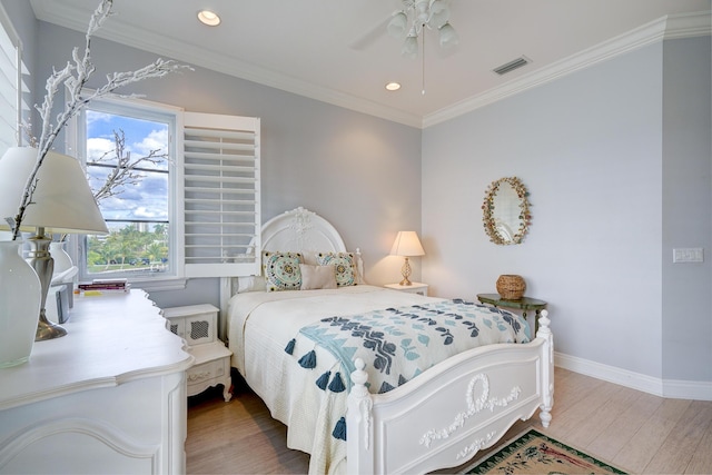 bedroom with wood-type flooring, ornamental molding, and ceiling fan