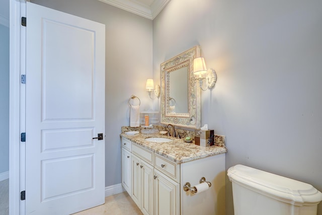 bathroom with crown molding, tile patterned floors, vanity, and toilet