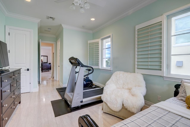 workout room featuring crown molding, ceiling fan, and light wood-type flooring