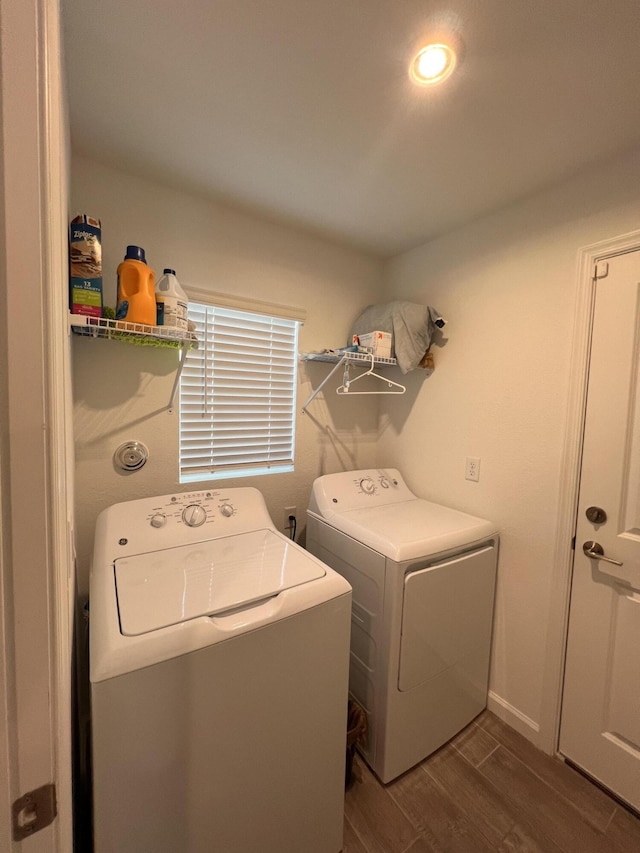 washroom featuring washing machine and clothes dryer and dark hardwood / wood-style flooring