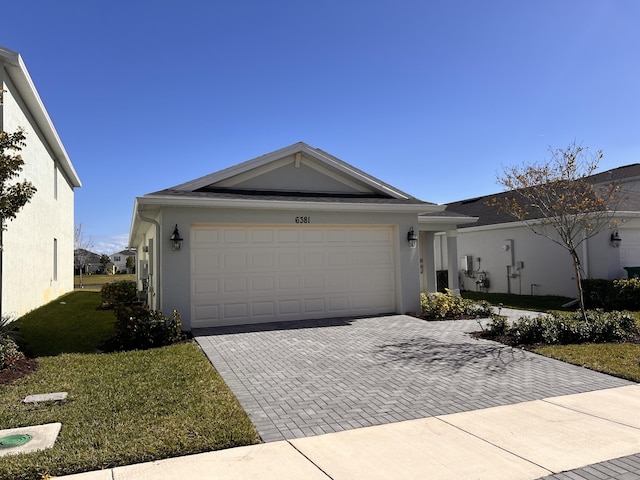 ranch-style home featuring a garage and a front yard