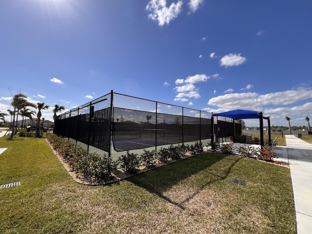 view of sport court with a yard