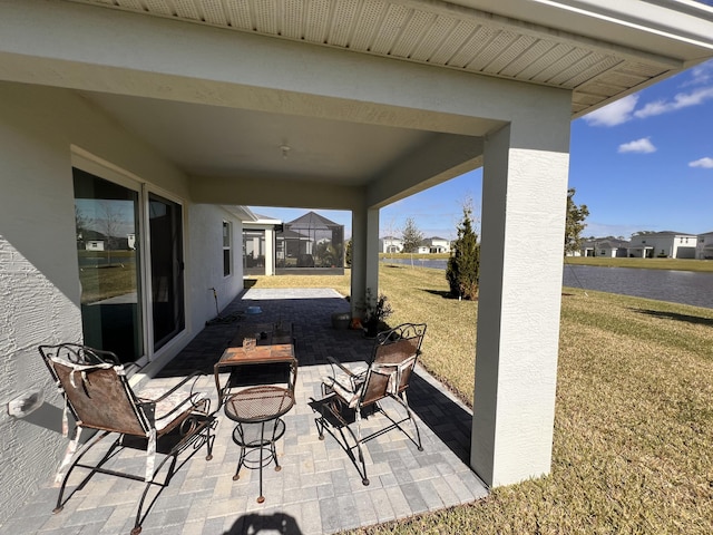 view of patio featuring a lanai