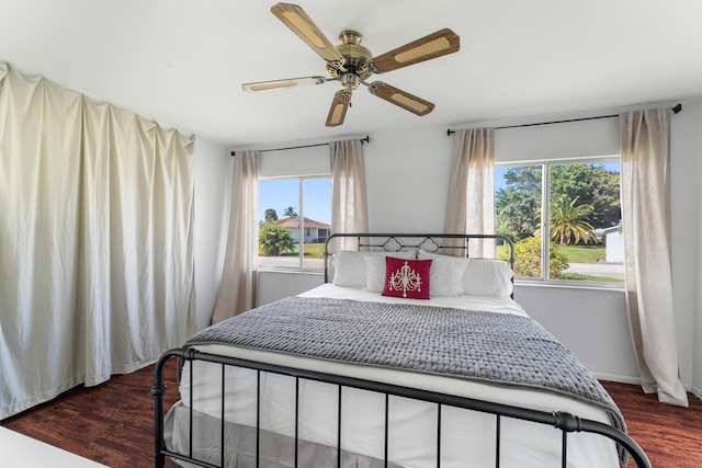 bedroom with ceiling fan and dark hardwood / wood-style floors