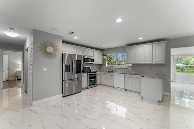 kitchen featuring appliances with stainless steel finishes, a healthy amount of sunlight, and sink