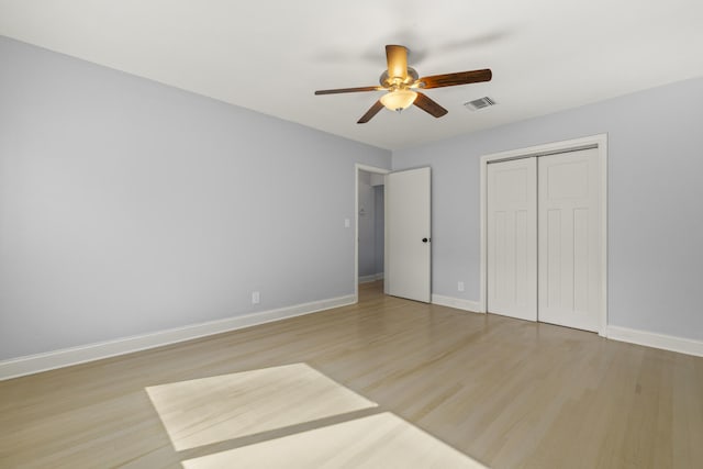 unfurnished bedroom with a closet, ceiling fan, and light wood-type flooring