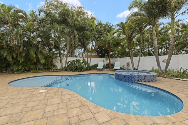 view of pool with an in ground hot tub and a patio