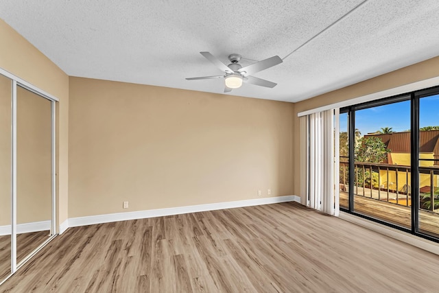 unfurnished bedroom featuring light hardwood / wood-style flooring, a textured ceiling, a closet, ceiling fan, and access to exterior