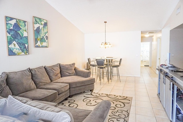 living room with vaulted ceiling, light tile patterned floors, and an inviting chandelier