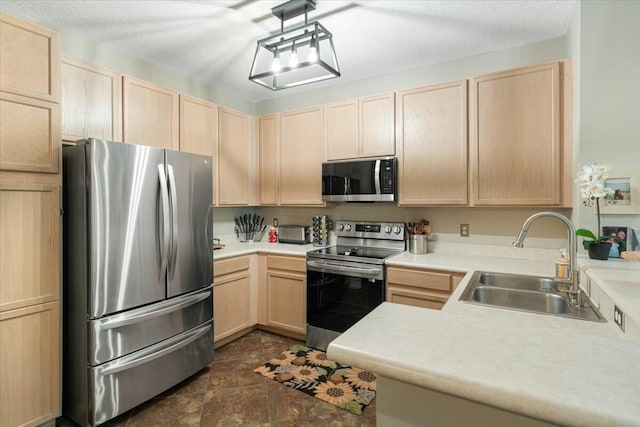 kitchen featuring stainless steel appliances and light brown cabinetry