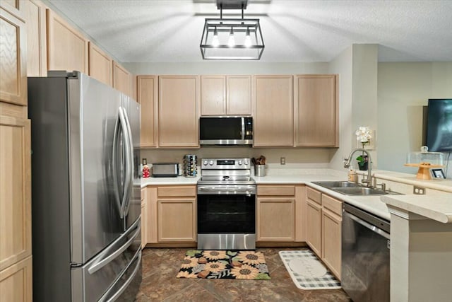 kitchen with stainless steel appliances, light brown cabinetry, and sink