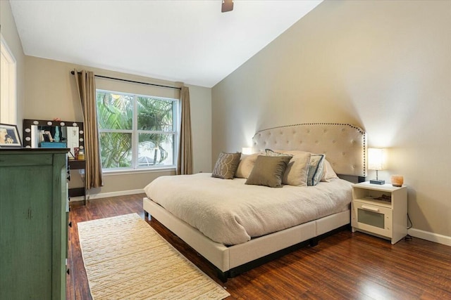 bedroom with vaulted ceiling, dark hardwood / wood-style floors, and ceiling fan