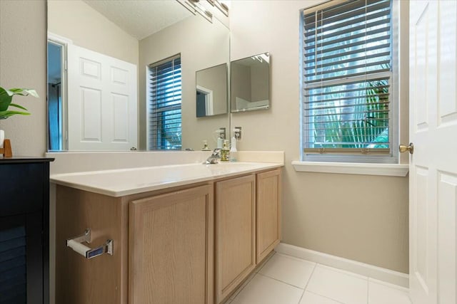 bathroom featuring tile patterned floors, a textured ceiling, and vanity