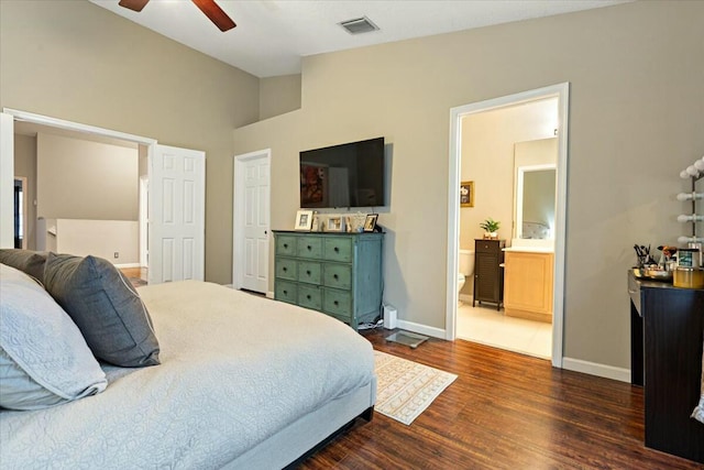 bedroom with vaulted ceiling, dark hardwood / wood-style floors, connected bathroom, and ceiling fan