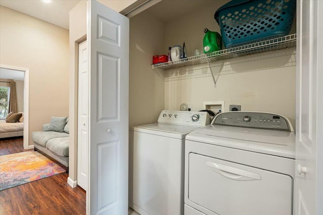 washroom featuring dark hardwood / wood-style floors and washer and clothes dryer