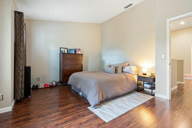 bedroom with dark hardwood / wood-style floors