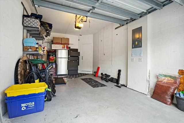 garage with a garage door opener and stainless steel refrigerator