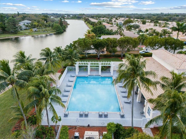 view of swimming pool with a pergola and a water view