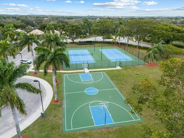 view of sport court with tennis court and a lawn