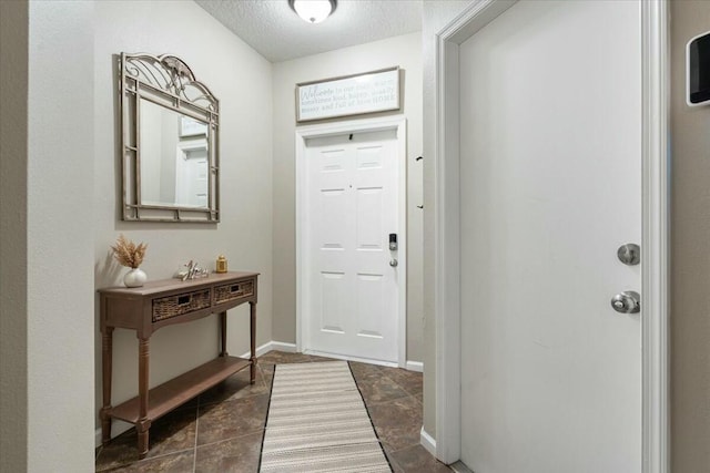 foyer entrance with a textured ceiling