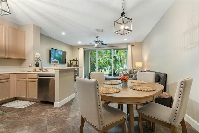 dining room featuring sink and ceiling fan