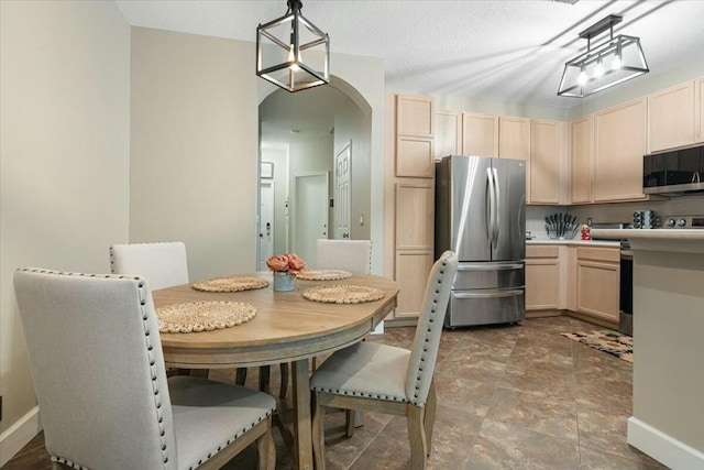 dining space featuring a textured ceiling