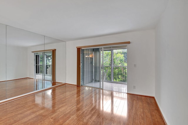 unfurnished room with hardwood / wood-style flooring and a wealth of natural light