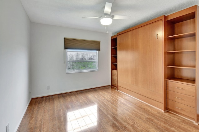 unfurnished bedroom featuring ceiling fan and light hardwood / wood-style floors