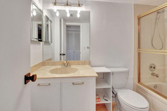 full bathroom featuring vanity, enclosed tub / shower combo, and toilet