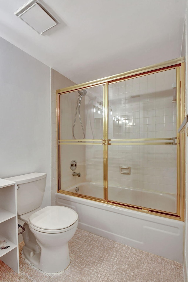 bathroom featuring tile patterned flooring, enclosed tub / shower combo, and toilet