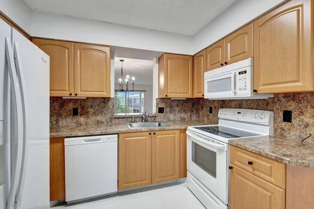 kitchen with an inviting chandelier, sink, white appliances, and decorative backsplash