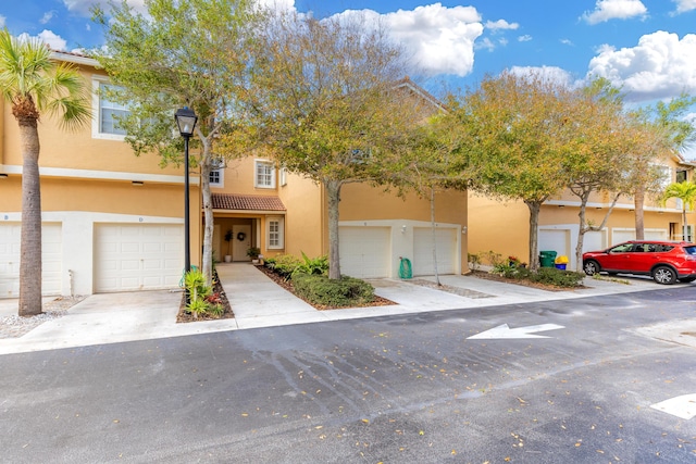 townhome / multi-family property featuring a garage