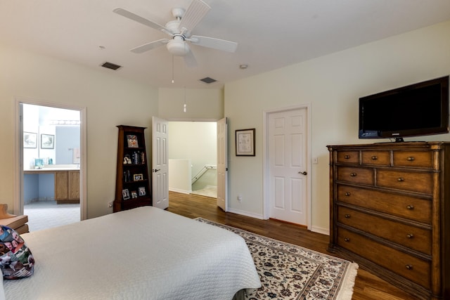 bedroom with dark hardwood / wood-style floors, ceiling fan, and connected bathroom