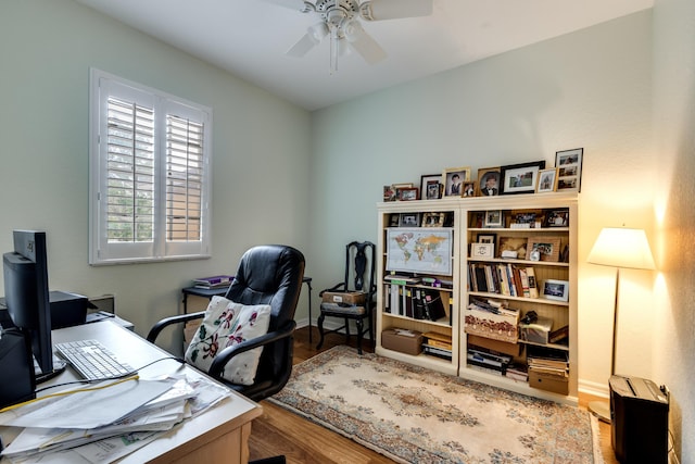 home office featuring hardwood / wood-style floors and ceiling fan