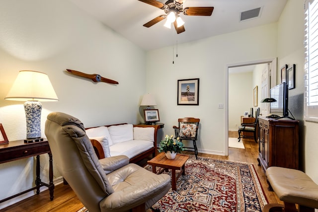 living room with hardwood / wood-style flooring and ceiling fan