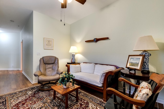 living room featuring dark hardwood / wood-style flooring, lofted ceiling, and ceiling fan