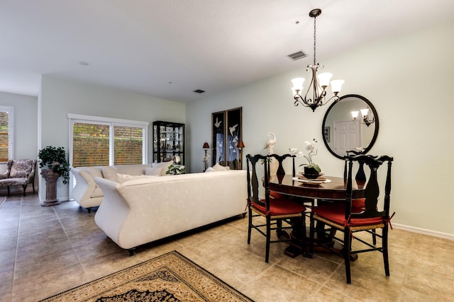 tiled dining room featuring an inviting chandelier