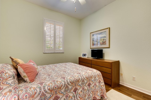 bedroom with hardwood / wood-style flooring and ceiling fan