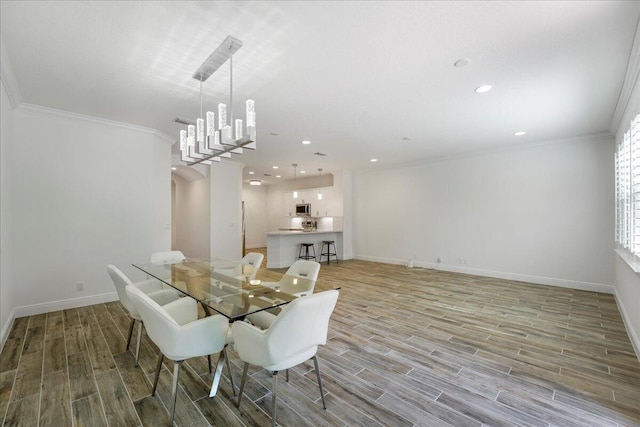 dining area with ornamental molding and a notable chandelier