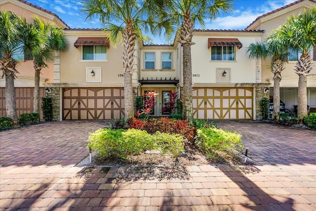 mediterranean / spanish-style house with a garage