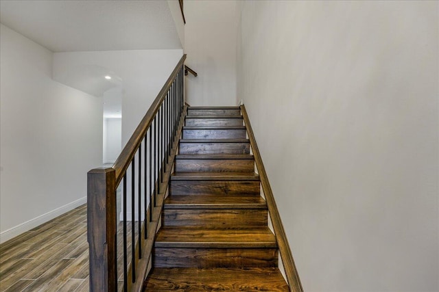 stairs featuring hardwood / wood-style floors