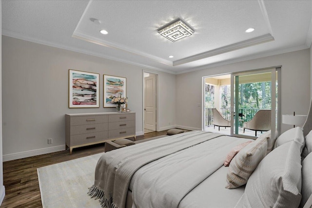 bedroom featuring a raised ceiling, crown molding, dark wood-type flooring, and access to outside