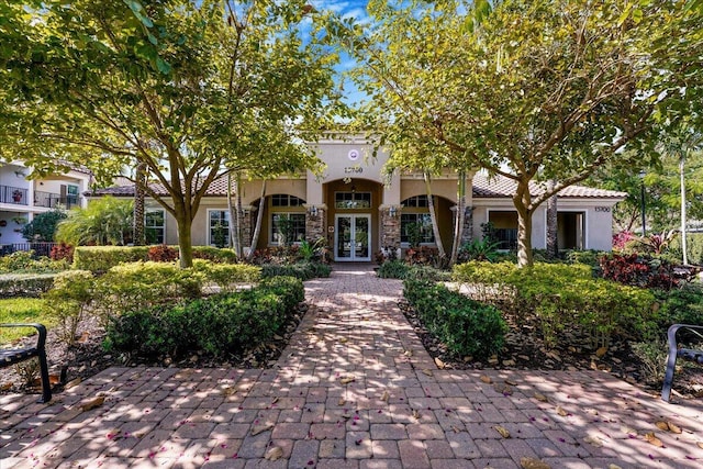 mediterranean / spanish-style house with french doors