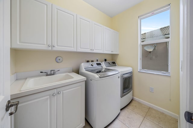 laundry area featuring cabinets, sink, independent washer and dryer, and light tile patterned floors