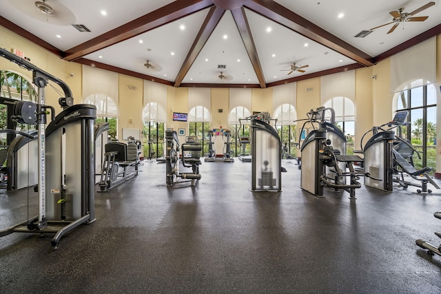 gym featuring ceiling fan and a high ceiling