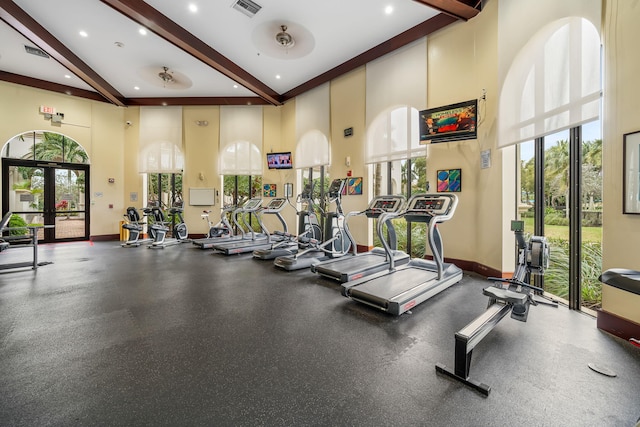 gym with a towering ceiling and a wealth of natural light