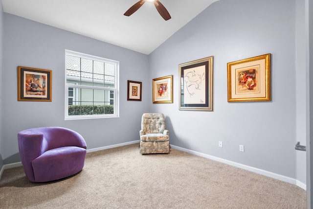 sitting room with lofted ceiling, ceiling fan, and carpet flooring