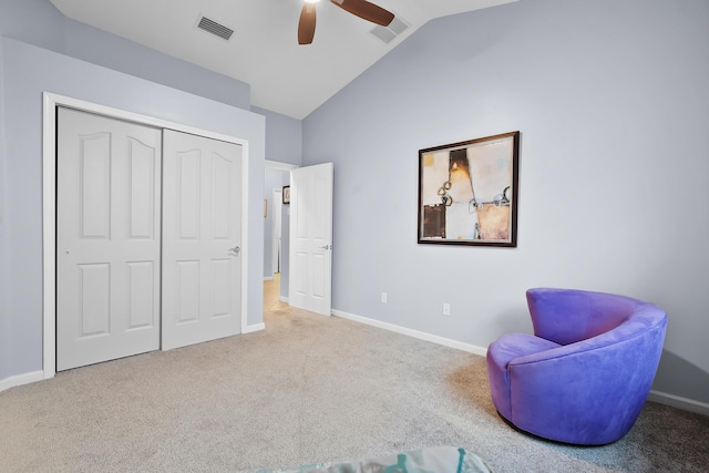 living area with ceiling fan, light colored carpet, and lofted ceiling